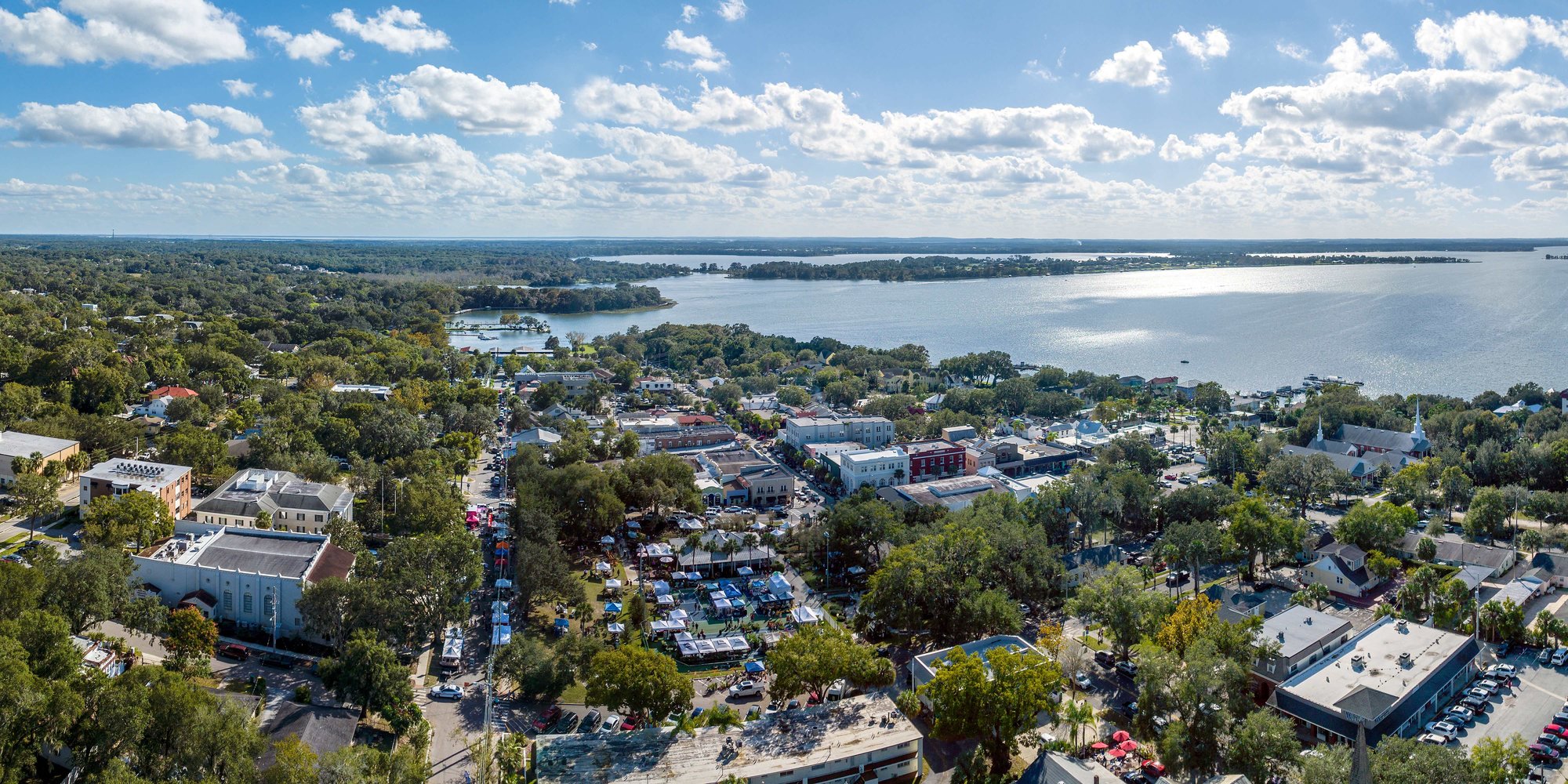 drone shot over mount dora with homes and a lake